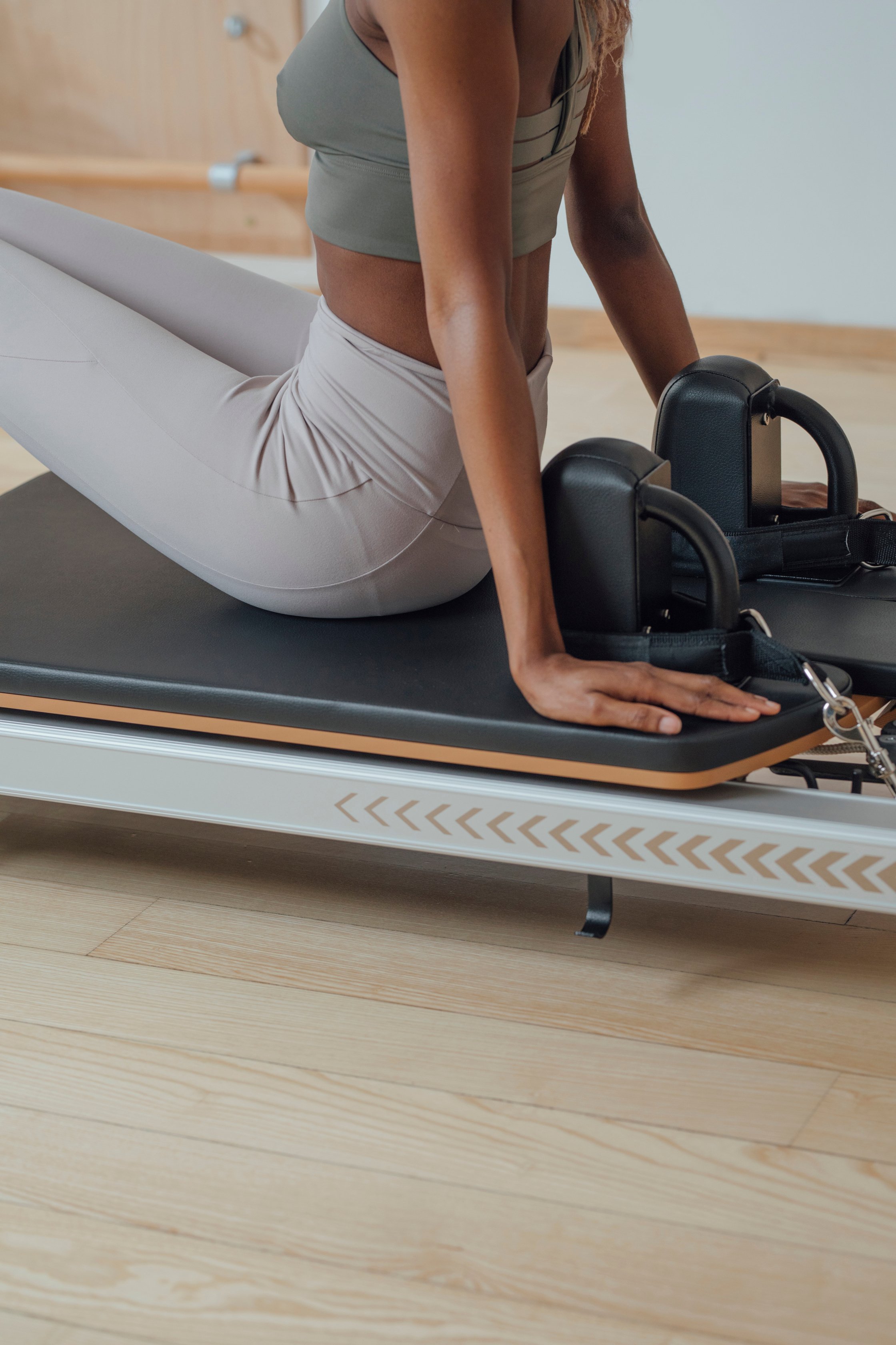 Woman Doing Pilates Exercise on Reformer